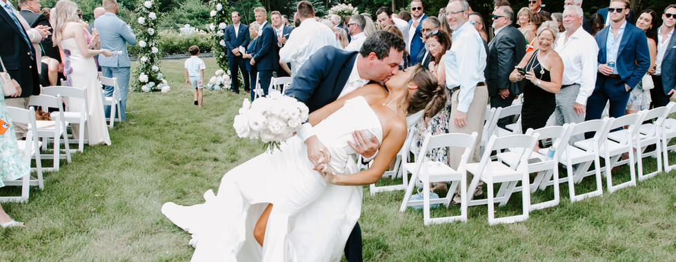 Bride and groom dip after wedding ceremony in Michigan