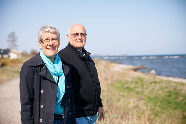 portrait-of-senior-couple-standing-at-sea-shore-on-2024-10-18-03-29-24-utc.jpg