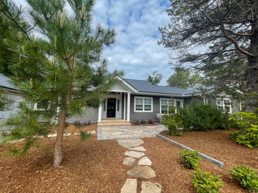 Elegant stone path connecting to a front yard patio, seamlessly integrating outdoor spaces with a charming and functional design
