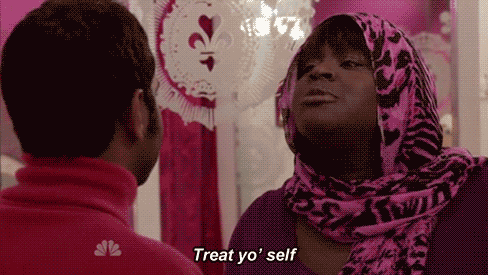 A gif from Parks and Recreation. Donna says "Treat yo' self" and Tom responds in glee.