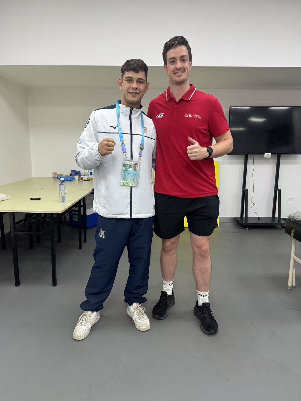 Fraser Oakman, Chiropractor poses with an athlete at The World Games in Chengdu, China