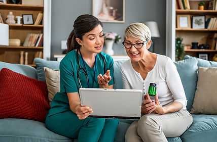 Paramedic facilitating telehealth visit with doctor and patient