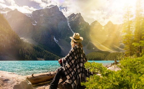 a-woman-sits-on-a-rock-beside-the-lake-2