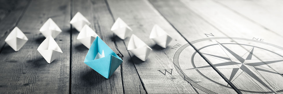 Blue-Paper-Boat-Leading-A-Fleet-Of-Small