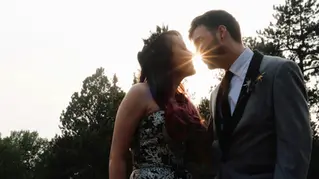 Bride and groom with sun behind them