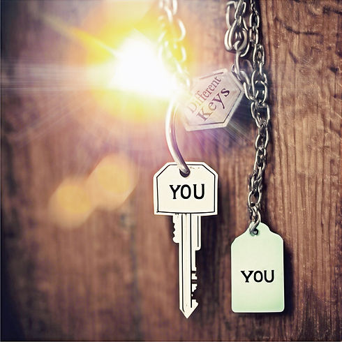 A key hanging on a chain, inscribed with 'you' and 'different keys', glinting in the light.