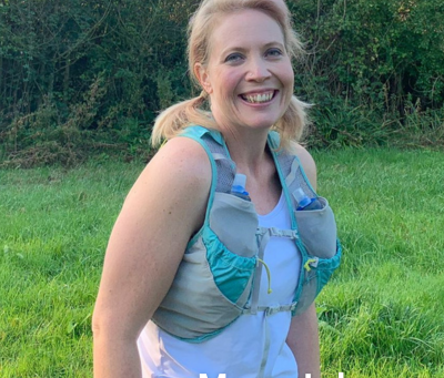 Smiling photo of run leader Mary Johnson in running gear