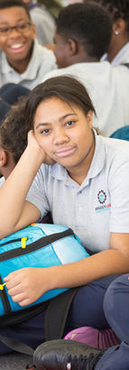 Brooklyn Lab student waiting with other students in the gym for a field trip.