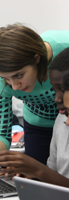 Brooklyn Lab middle school students with teacher pointing to computer screen