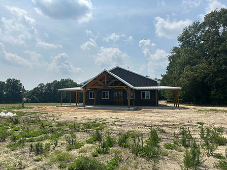 Post frame construction pole barn garage with living space, concrete floor, metal walls an