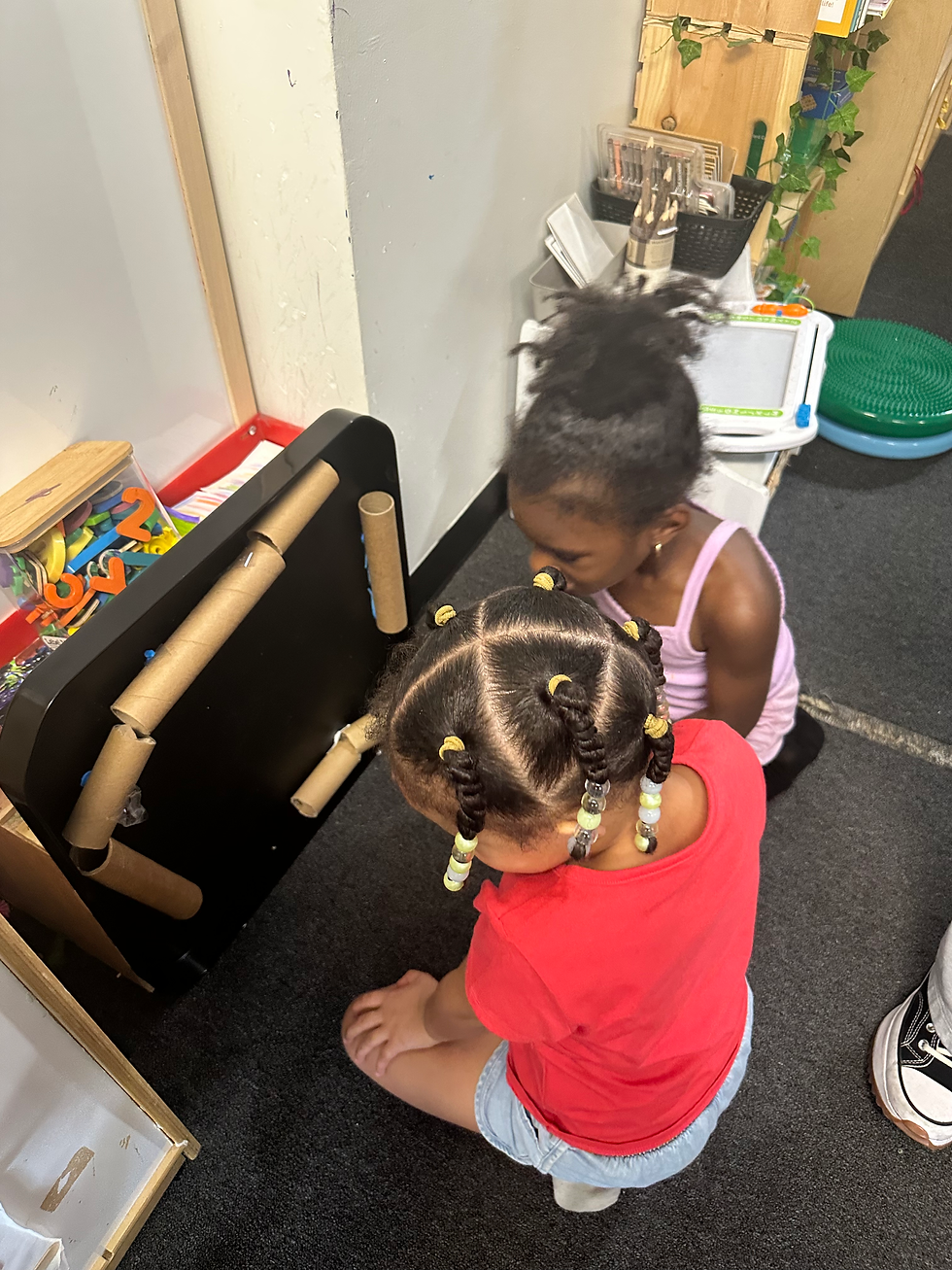 Campers set up gravity run with marbles and cardboard