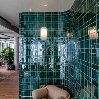 Tilers in London completing elegant bathroom tiles at Mason & Fifth Hotel