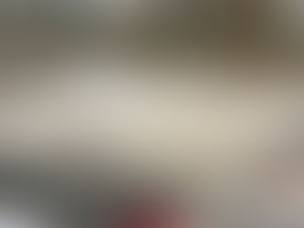 Close-up of water jet cutting in progress on large-format shower former tiles, showing precise diagonal cuts with water stream and tile secured on the machine bed at Affordable Granite's facility.