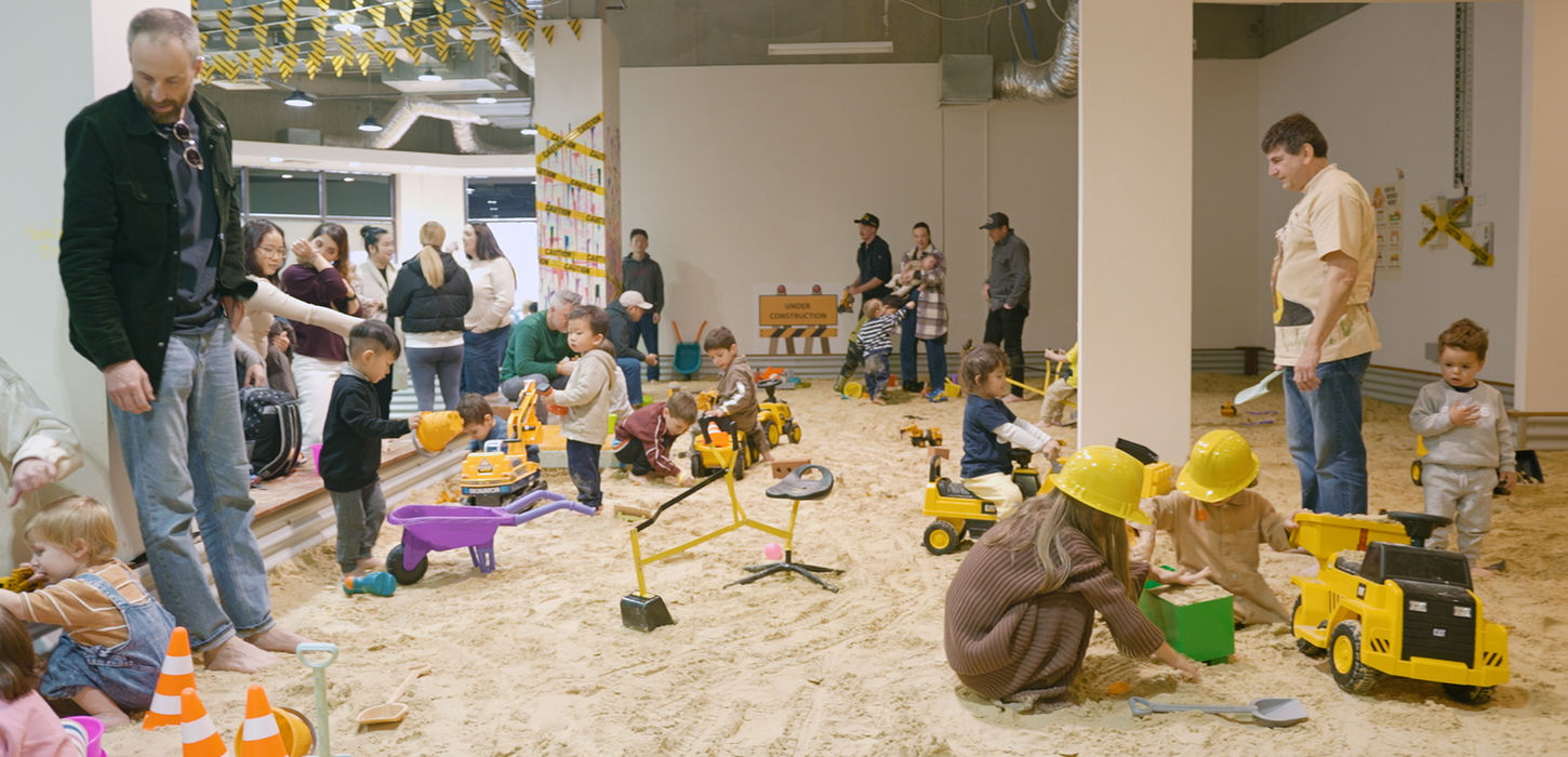 Children playing with construction toys in an indoor sandpit