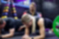 Clients do a plank during group PT session