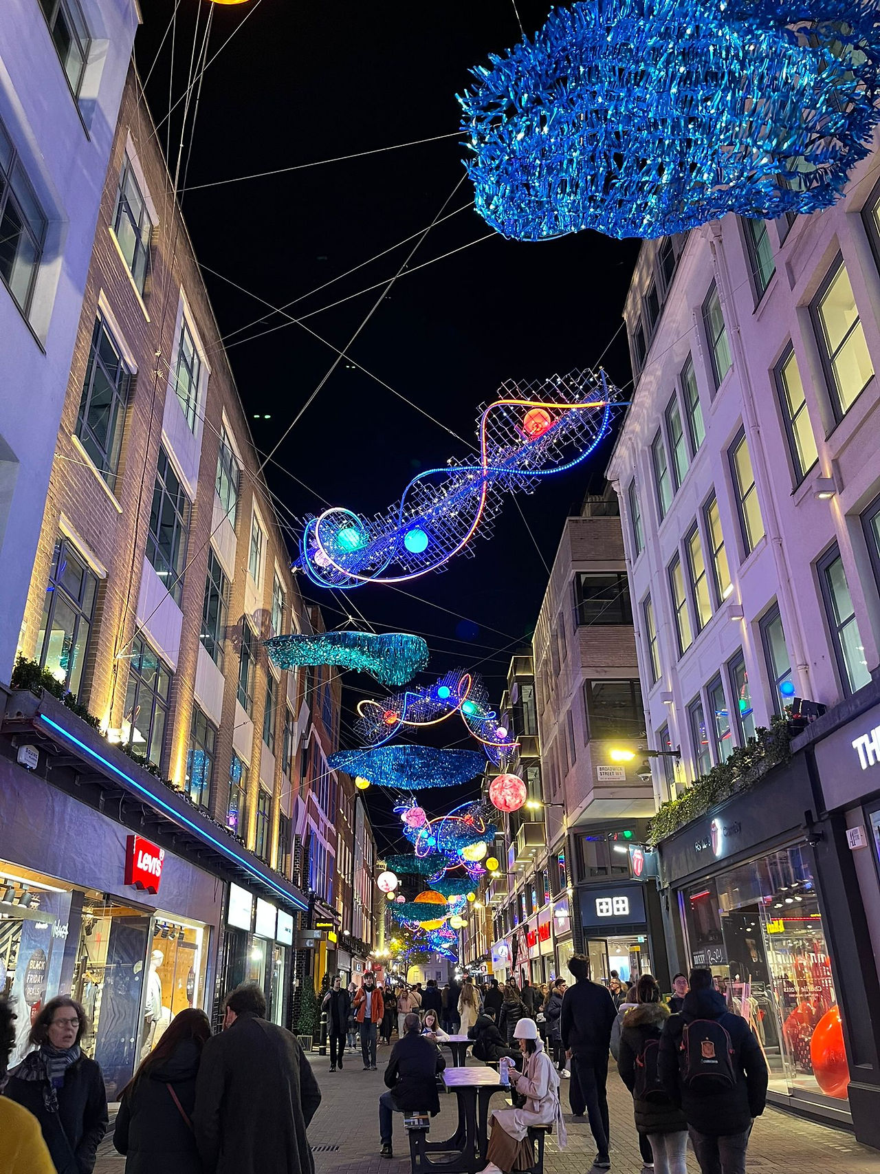 Vibrant and colorful planets decorating Carnaby Street during the festive season