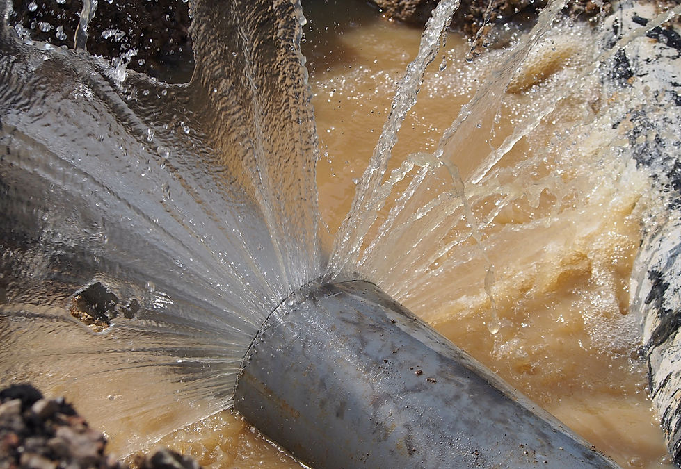 Close-up of a well drilling process with water forcefully spraying as a drill penetrates the earth, demonstrating effective drilling techniques.