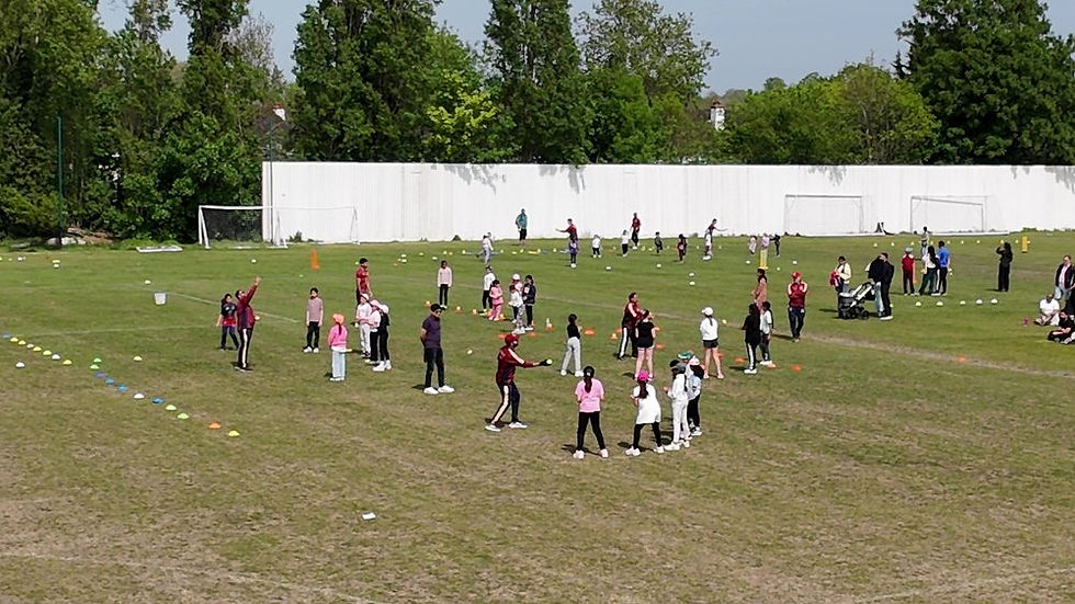 Junior coaching session on the outfield at Cheam Cricket Club