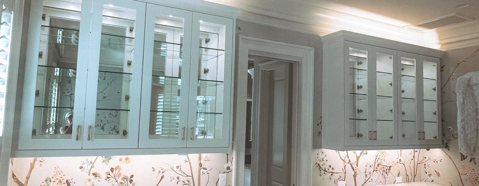 Custom lighting throughout dining room cabinets with hardwood floors and cherry blossom wallpaper