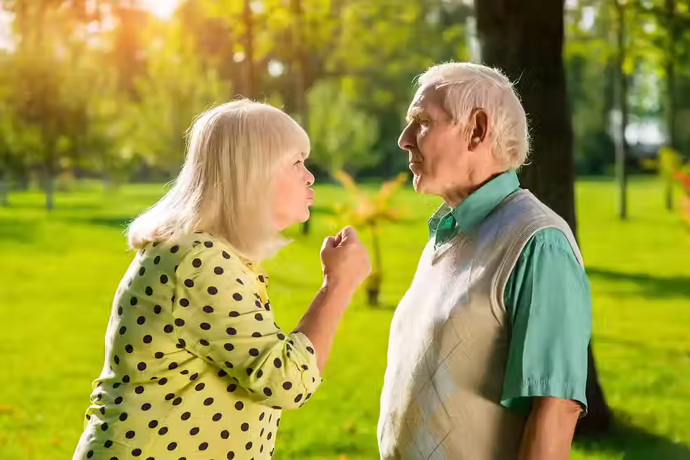 What is grey divorce - an image of two people, a man and a woman, who could be elderly, arguing in an outdoor space.