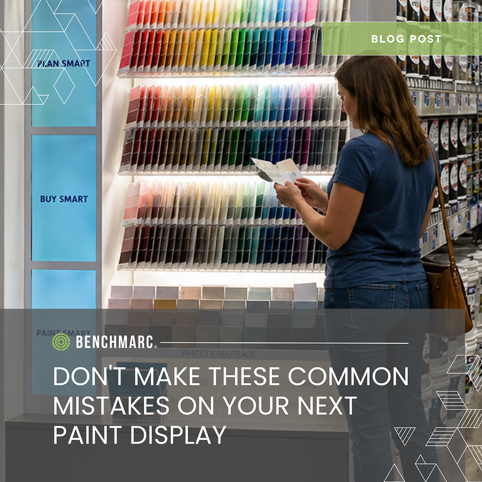 Customer shopping an interactive Benchmarc paint display featuring paint color samples, digital visualization tools, finish comparisons, and retail merchandising elements inside a home improvement store.