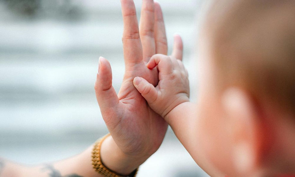 Baby and adult hands touching