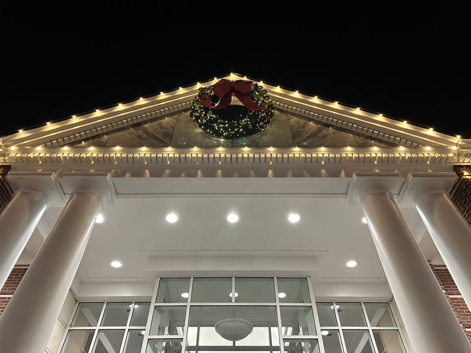Close up of city building with wreath and lights
