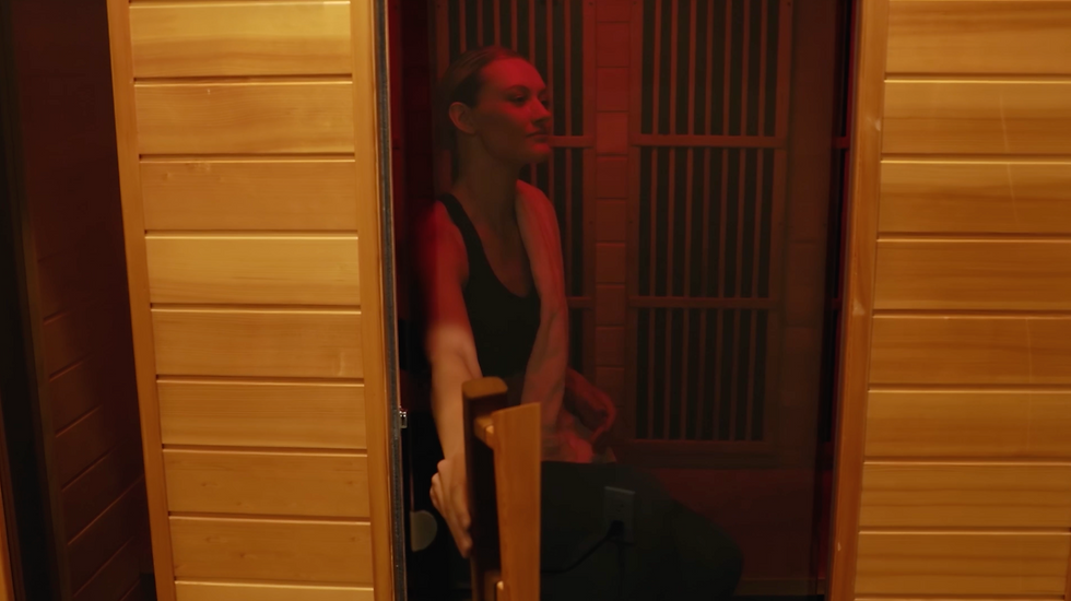 Eye-level view of a modern infrared sauna cabin with glowing panels