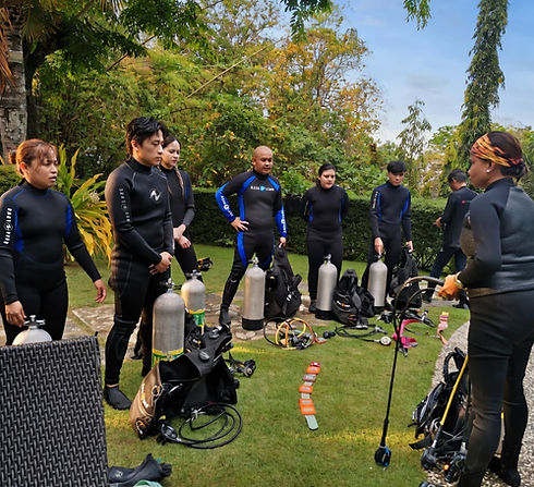 Divers assembling gear and attending a small fun dive orientation before exploring the waters of Anilao with Maharlika Dive Center.
