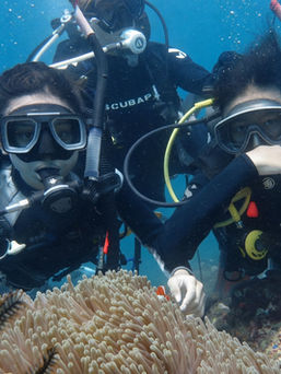 Beginner scuba diver giving OK sign underwater in Batangas Philippines