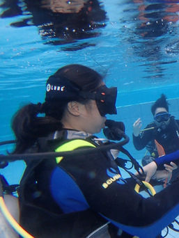 First-time diver practicing scuba skills in swimming pool with Maharlika Dive Center at Layag Resort