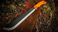 Eye-level view of a machete resting on a wooden table