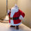 Thumbnail: Close view of the 3D printed Santa on a bedside table beside a lamp.