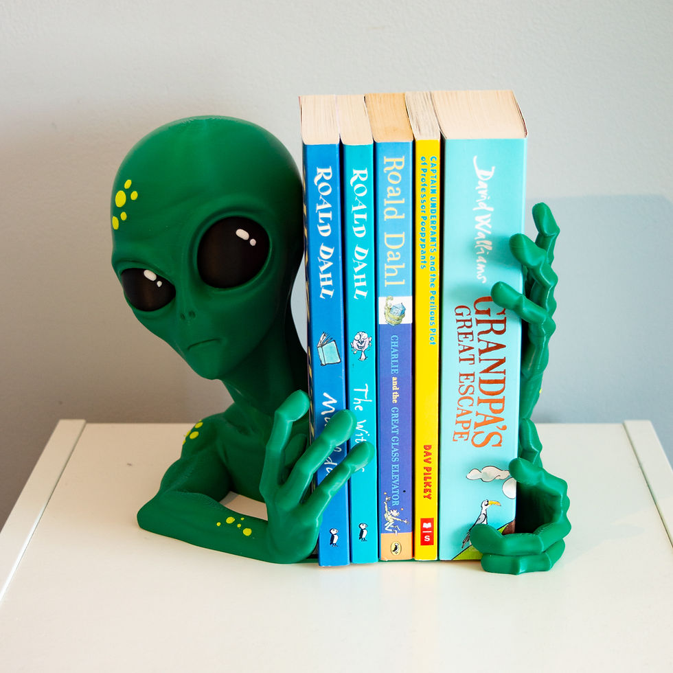 Thumbnail: Angled shot of alien bookend hand gripping side of book stack with detailed fingers and green paint finish