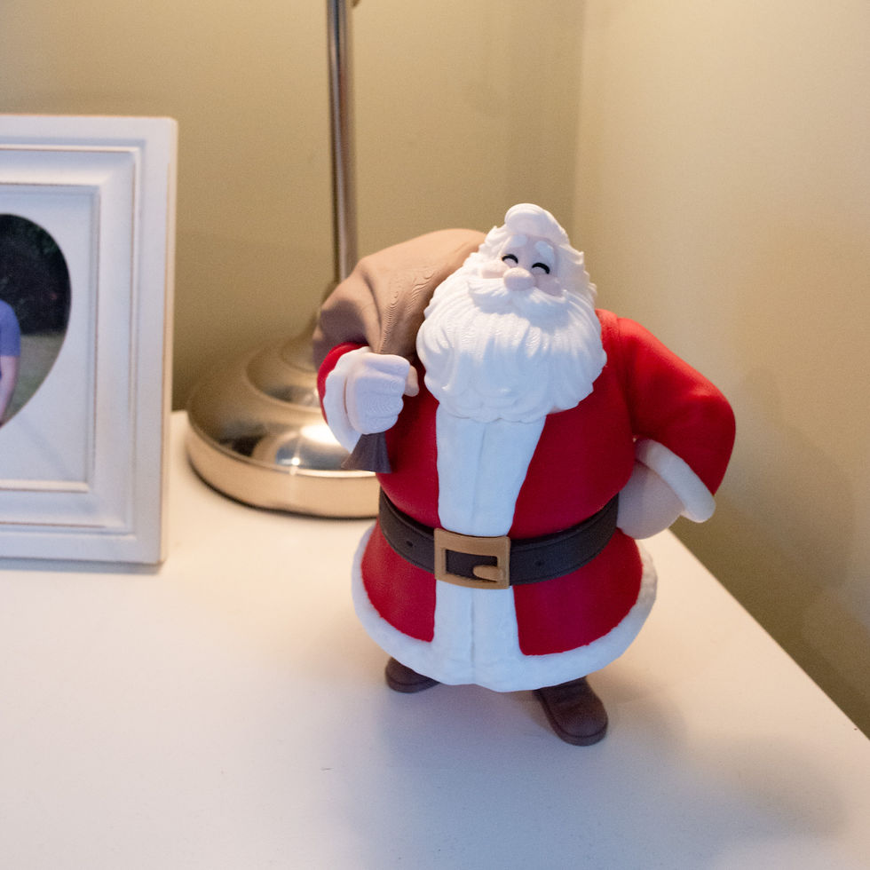 Thumbnail: 3D printed Santa displayed on a bedside table next to a lamp and photo frame.