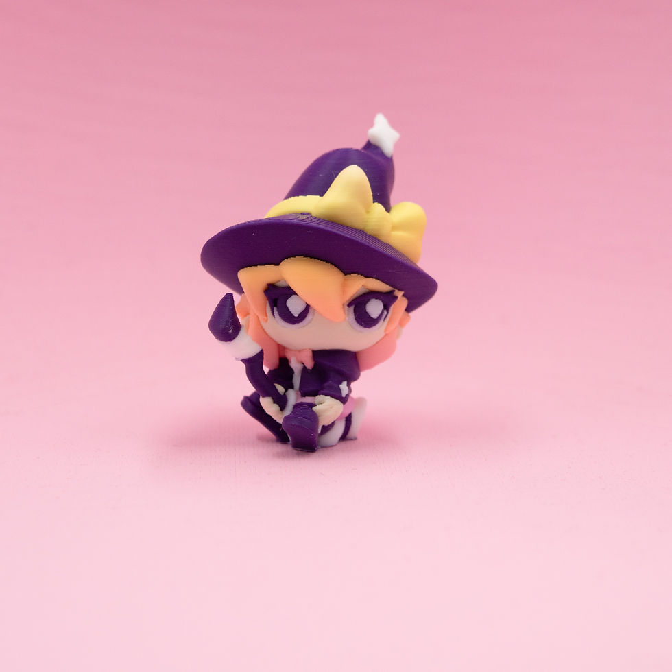 Thumbnail: Angled view of witch figurine highlighting hat, bow, and colour accents