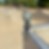 Small hooded figure Hazy sits on a skate ramp edge, staring at his phone, with empty ramps in the background.