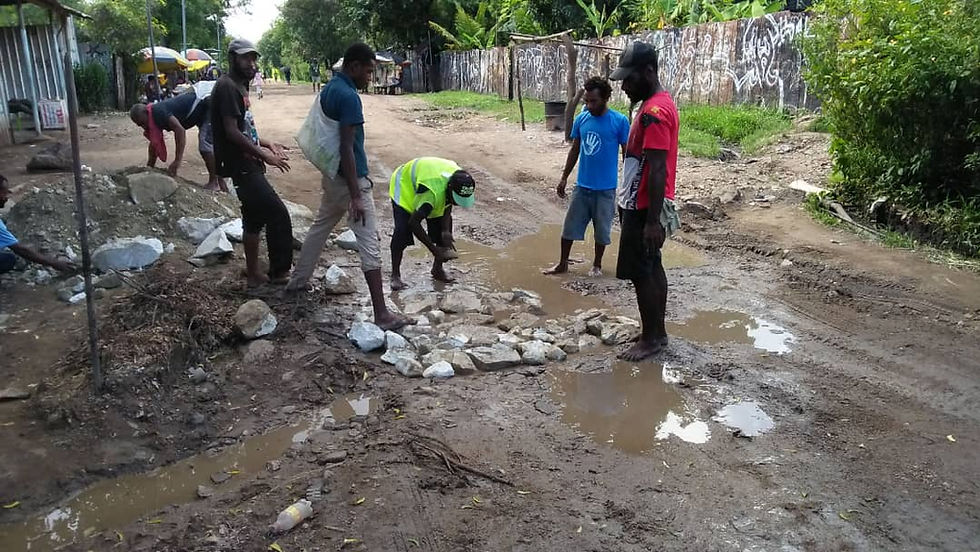 9-Mile Settlement, Morobe Block. Stones are used to fill pt-holes before being filled in with dirt