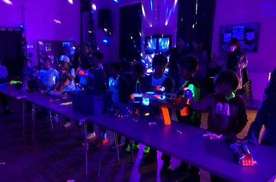 Ultra violet lighting with children shooting nerf guns