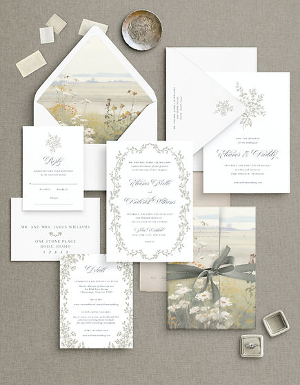 The "Beaumont" wedding invitation suite, featuring a delicate wildflower and botanical theme. Includes an ethereal landscape