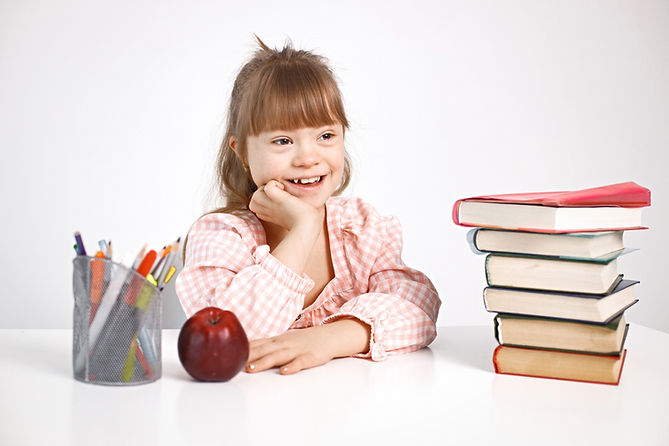 girl-with-down-syndrome-studying-while-sitting-desk-home (1).jpg