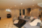 Basement remodel in Maple Leaf, Seattle featuring a finished family room with open layout, recessed lighting, and modern living space design.
