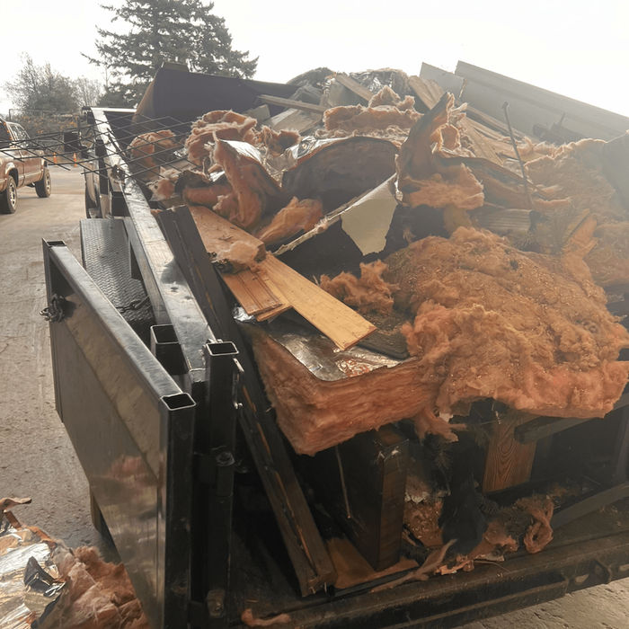 Utility trailer filled with construction waste and old insulation ready for disposal in Ferndale.