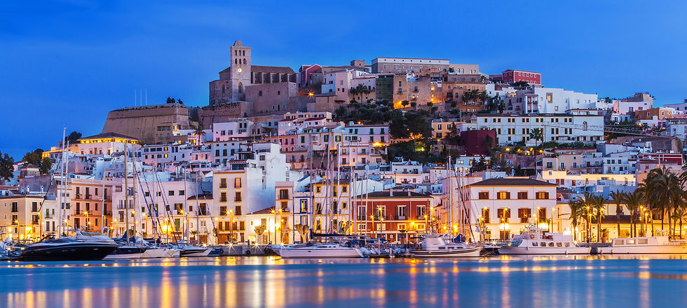 Ibiza Town harbour and Dalt Vila old town lit up at dusk