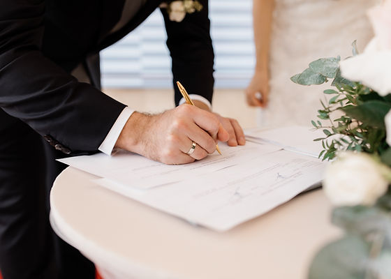 couple love is signing official marriage documents