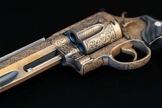Smith and Wesson 500 Magnum Performance Center revolver with custom laser engraved scrolls and burnt bronze cerakote finish.