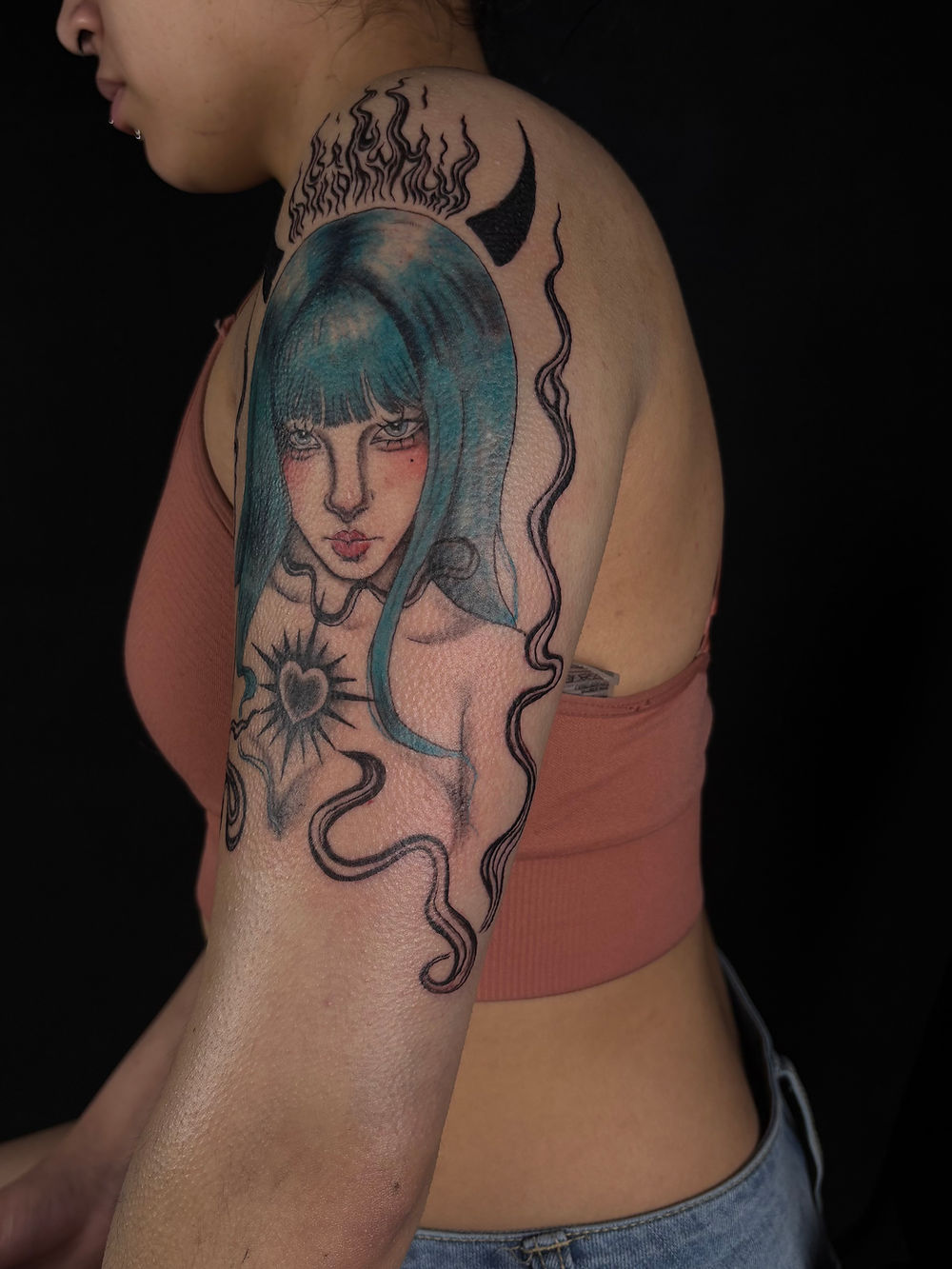 Blue-haired horned girl tattoo outer arm angle