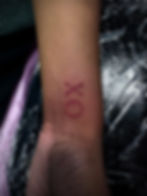 XO tattoo on a wrist by Megan May