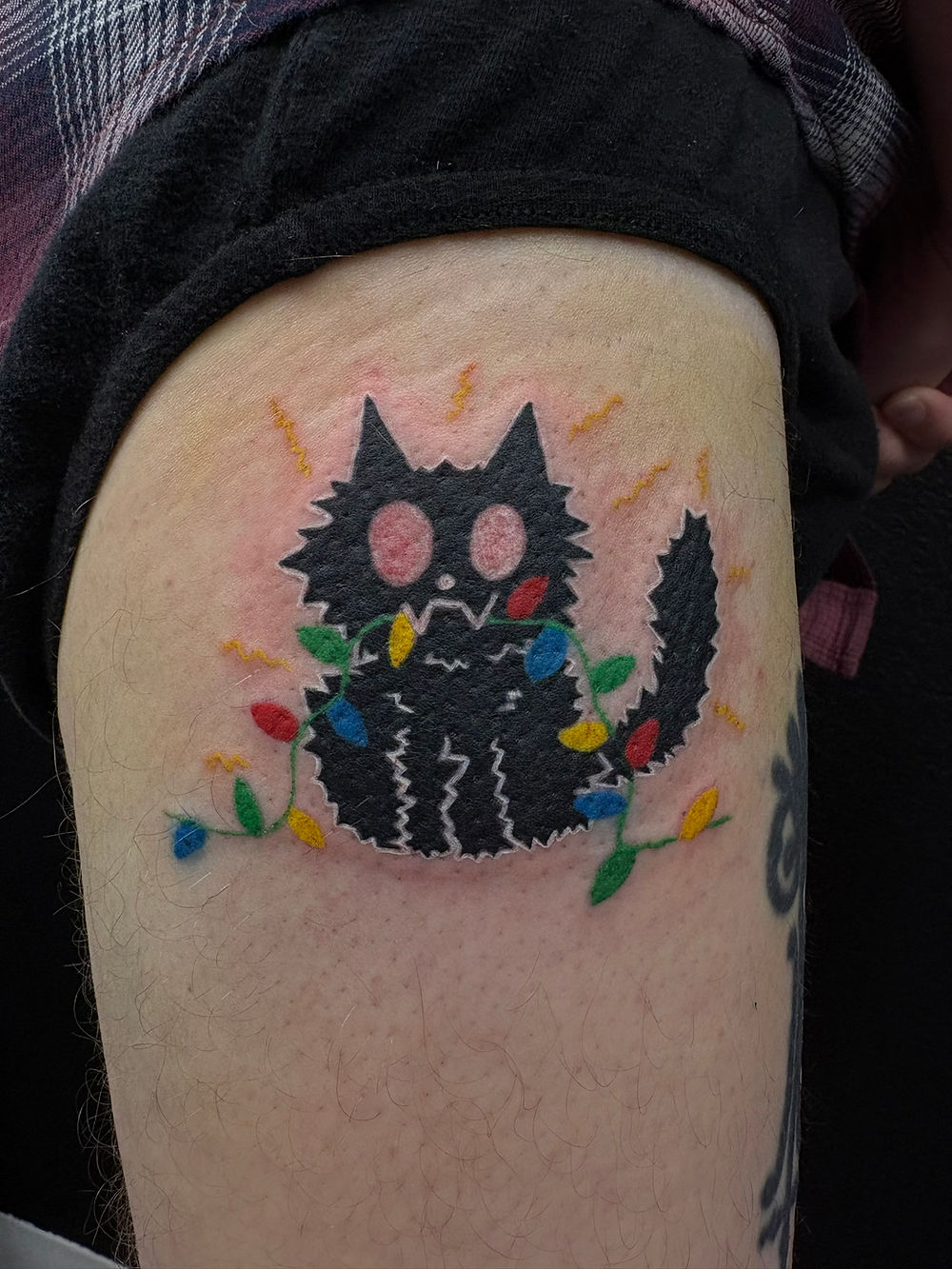 Black cat tangled in colorful lights tattoo by Megan May