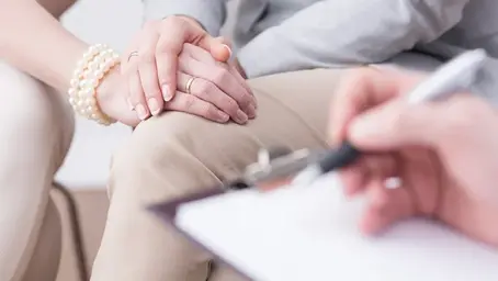 Couple holding hands during a therapy session, representing support for painful relationship patterns and couples counselling